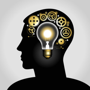 silhouette of a man's head with a glowing light bulb, and gears.